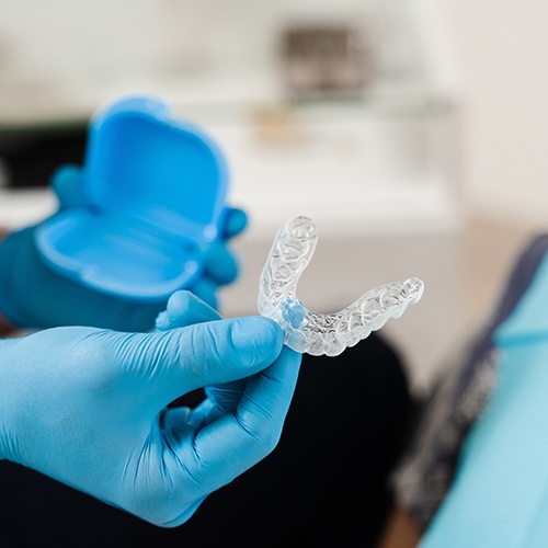 Dentist handing patient clear aligner