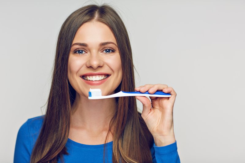 closeup of person smiling while brushing teeth